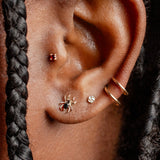Close-up of an ear with earrings and braided hair
